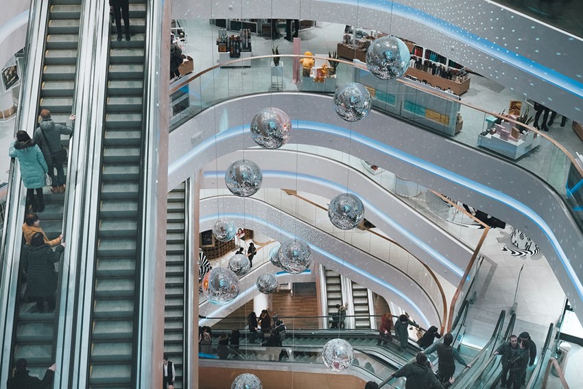 People on an escalator in a shopping mall
