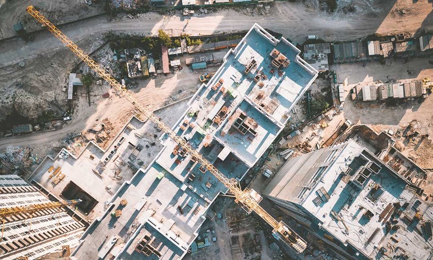 crane hovering over a construction site