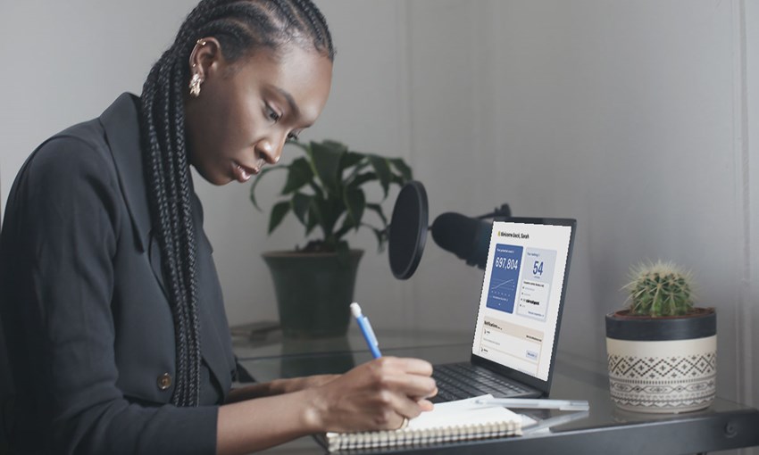 Woman working on a laptop with the BIMobject business app displayed on the screen