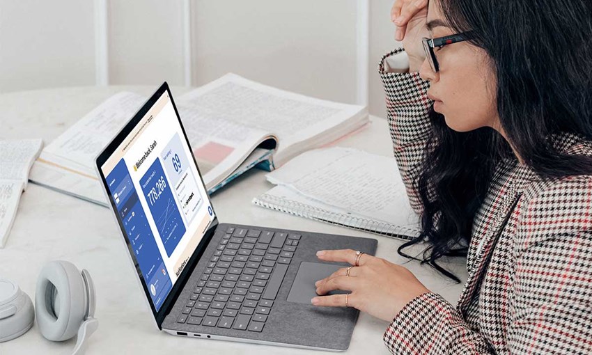 woman working on laptop. Laptop displaying BIMobject business app for manufacturers