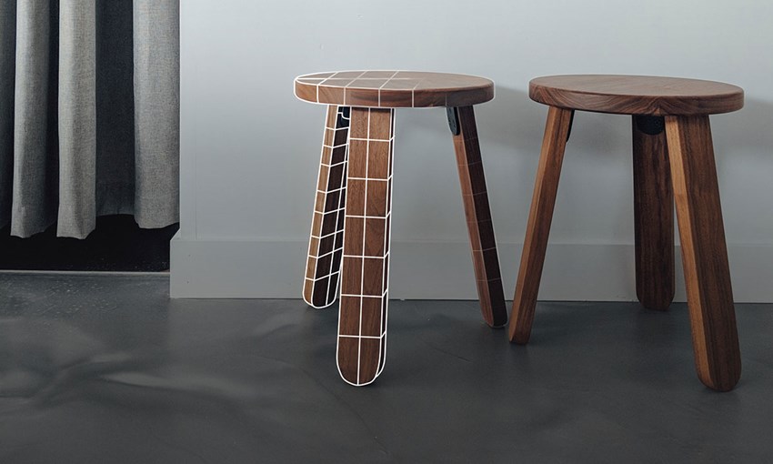a couple of stools in a room, grid covers one leg to signal BIM content: digital replicas of products