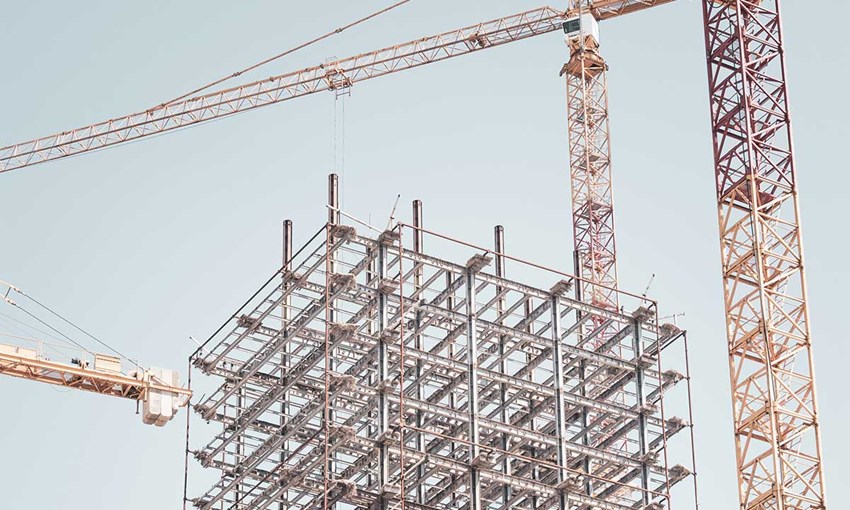 Construction site with scaffolding and cranes